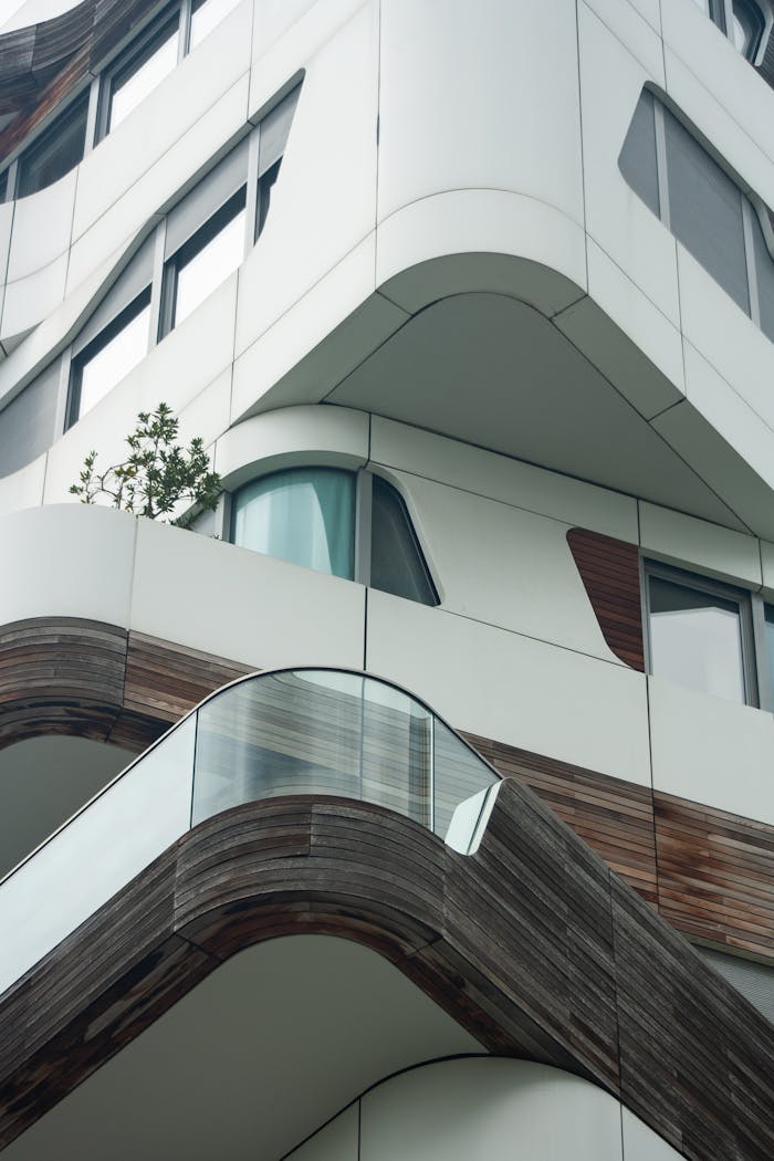 Modern building with curved design and glass elements in Milan, Italy.